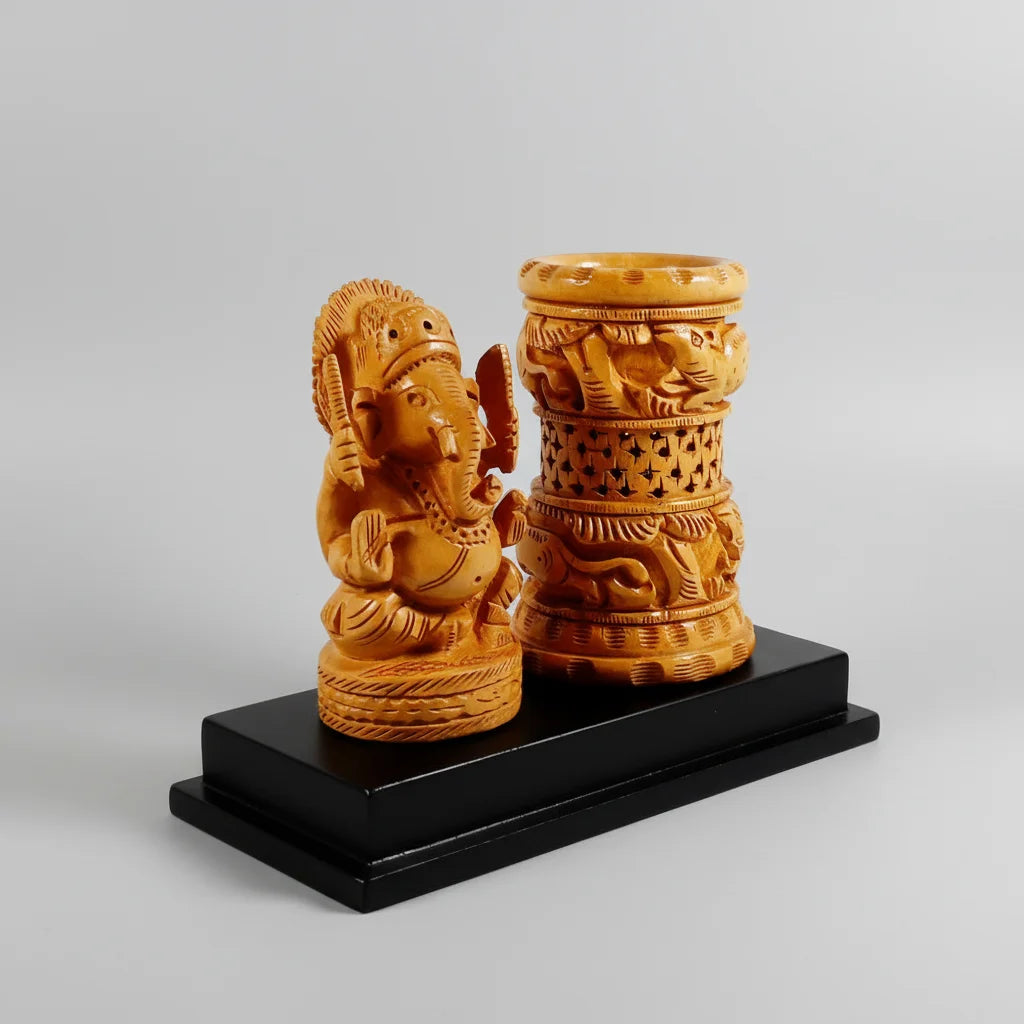 A professional office desk setup featuring a wooden Ganesh pen stand holding pens and pencils for a tidy workspace.