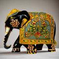 Wooden hand-painted elephant figurine in black with golden emboss and floral design