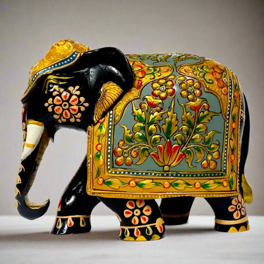 Wooden hand-painted elephant figurine in black with golden emboss and floral design