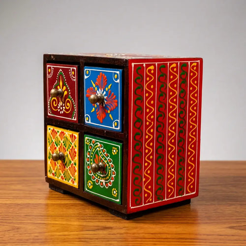 Four-drawer wooden jewellery organizer with multicoloured drawer fronts and a red patterned side panel