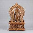 Back view of handcrafted wooden Krishna idol showing intricate jali arch detailing — Jaipur wood carving