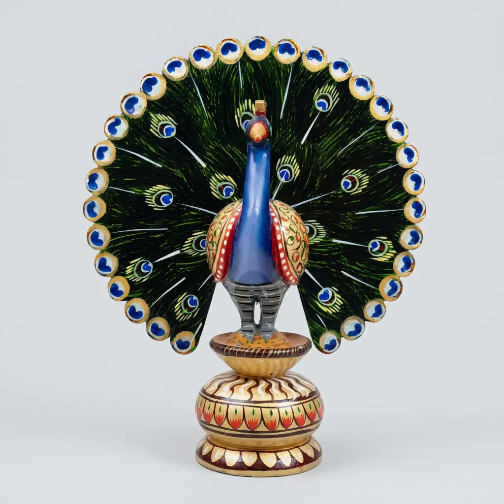 Hand-painted wooden dancing peacock with a blue neck, green fan-shaped tail and floral-patterned pedestal