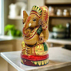 A beautiful hand-painted wooden idol of a round-shaped Ganesha.