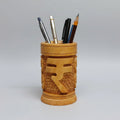A cylindrical 10cm wooden pen holder featuring a deeply engraved Indian Rupee symbol on a polished natural wood surface.