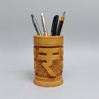 A cylindrical 10cm wooden pen holder featuring a deeply engraved Indian Rupee symbol on a polished natural wood surface.