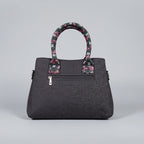 Rear view of jacquard woven handbag showing the secure back zip pocket