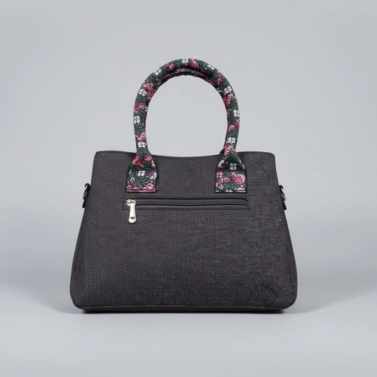 Rear view of jacquard woven handbag showing the secure back zip pocket