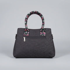 Rear view of jacquard woven handbag showing the secure back zip pocket