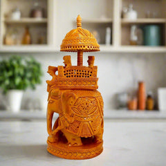 A 23cm hand-carved wooden elephant with a canopy over a throne.