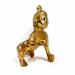 Closeup pure brass Child Krishna idol for daily aarti, divine Hindu temple decor piece.