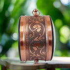 An antique hanging wall clock with a clock on either side, its stunning design grabs everyone's attention.