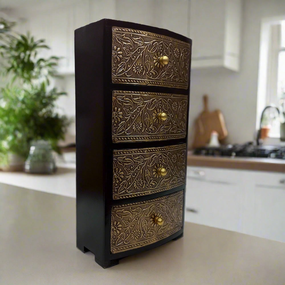 Antique wooden box with four drawers, accented with metal floral leaf work on top and front for a luxurious look.