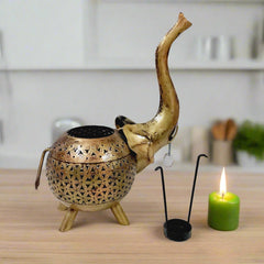  Artistic golden metal elephant candle stand with intricate meshwork, enhancing ambiance with candlelight.