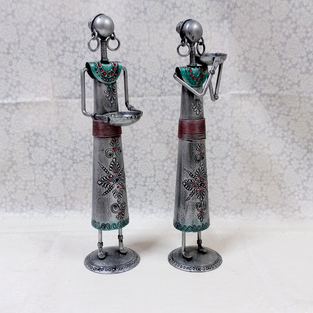 Artistic tribal lady metal candle holders with silver oxidized finish and detailed emboss work, ideal for gifting and decoration.
