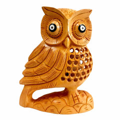 Detailed big eyes and all-around carving on lucky wooden owl showpiece symbolizing prosperity

