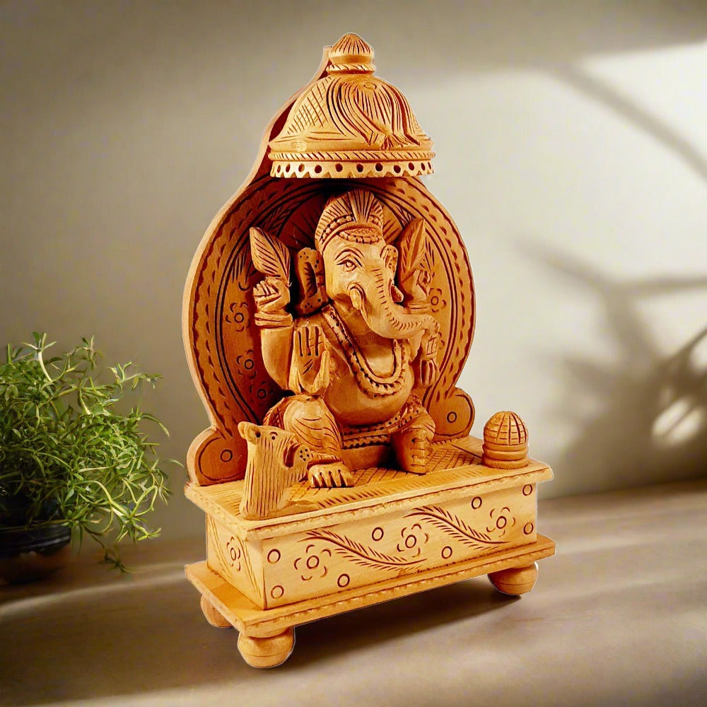 Wooden blessing Ganesha statue featuring a top side carved chattar and intricate wood carving.