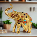 Handcrafted pure brass lucky elephant with upright trunk and colorful stone inlays, 12cm Rajasthan decor piece.