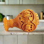 Side view showing fine flower elephant carvings on exquisite wood vase.