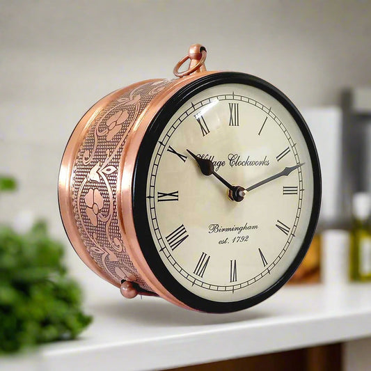 A classic railway clock with a metal stand, perfect for home and office decoration.