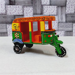 Colorful handcrafted wooden auto rickshaw showpiece with detailed hand art, suitable for gifting and decor.

