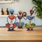 Colorful hand-painted Rajasthani musician metal set featuring three figures with vibrant traditional attire and instruments.

