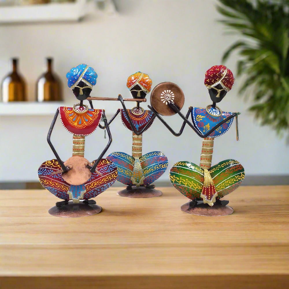 Colorful hand-painted Rajasthani musician metal set featuring three figures with vibrant traditional attire and instruments.

