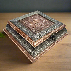 Front view of wooden dry fruit box with copper oxidized raised peacock design and four partitions