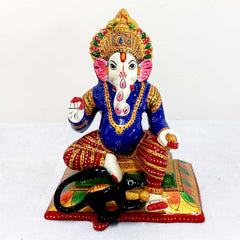 Decorative metal Ganesha idol with vibrant meenakari paint, rat eating laddoos detail, suited for spiritual decor