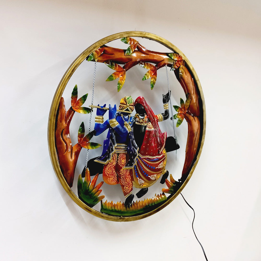 Decorative metal wall frame of Radha Krishna with integrated LED light and beautiful hand-painted design.