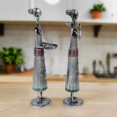Decorative metal candle holders showing tribal ladies holding bowls for candles, adorned with emboss and silver oxidized finish.