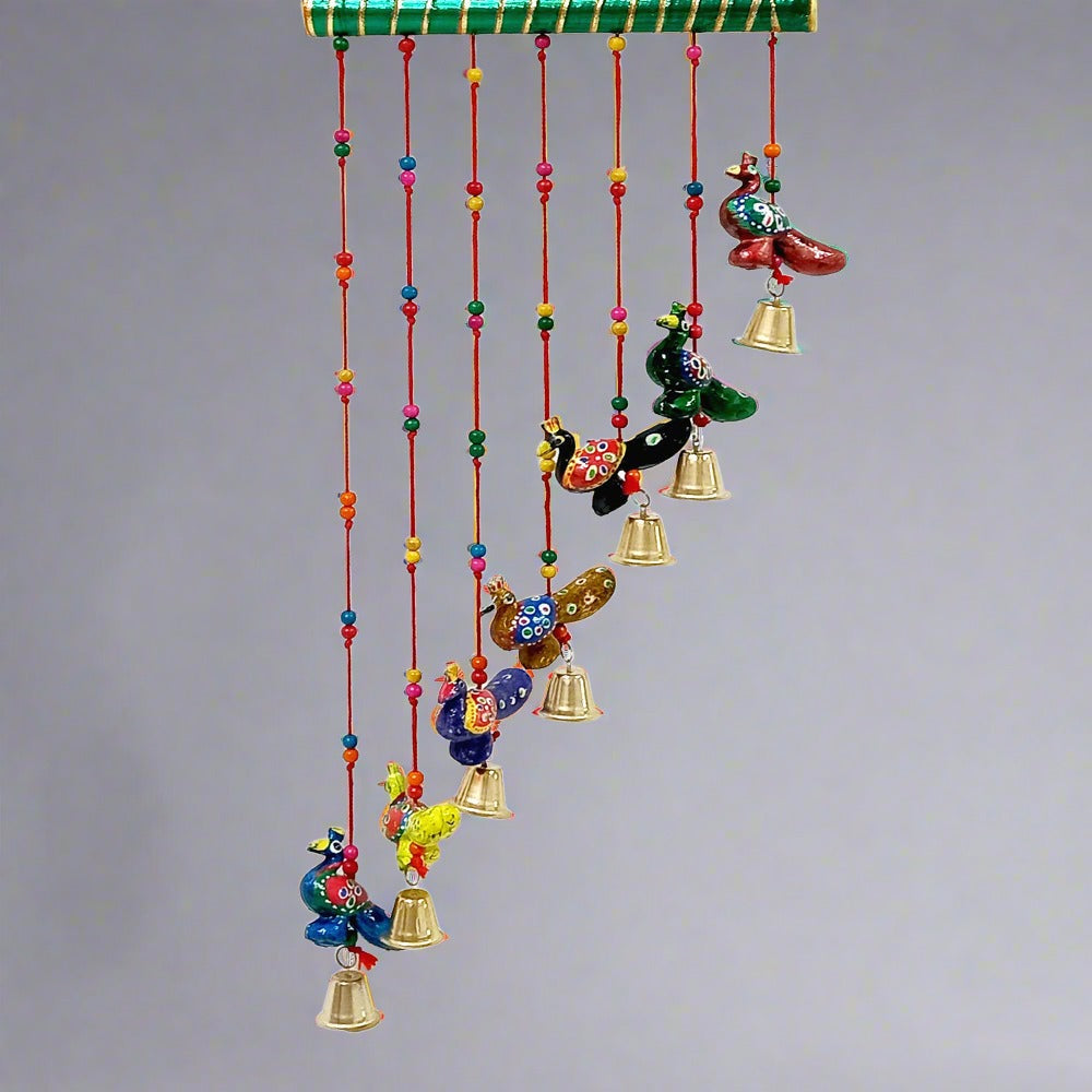 Slant design peacock toran made from paper mache, featuring beads, thread, and decorative stick.