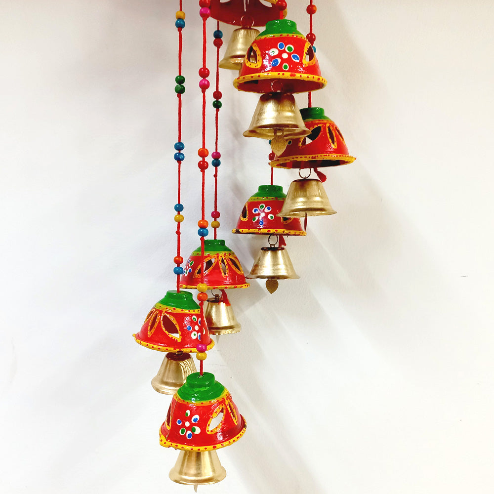 A very amazing wall hanging decorated with golden bells and beads.