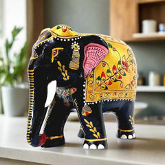 An amazing wooden elephant statue with a down trunk, made with an artisan's skill.
