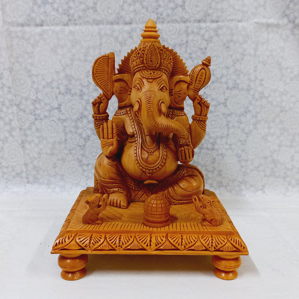 Elegant wooden Ganesh ji idol on decorative chowki, made of kadam wood with intricate hand craftsmanship for home worship.