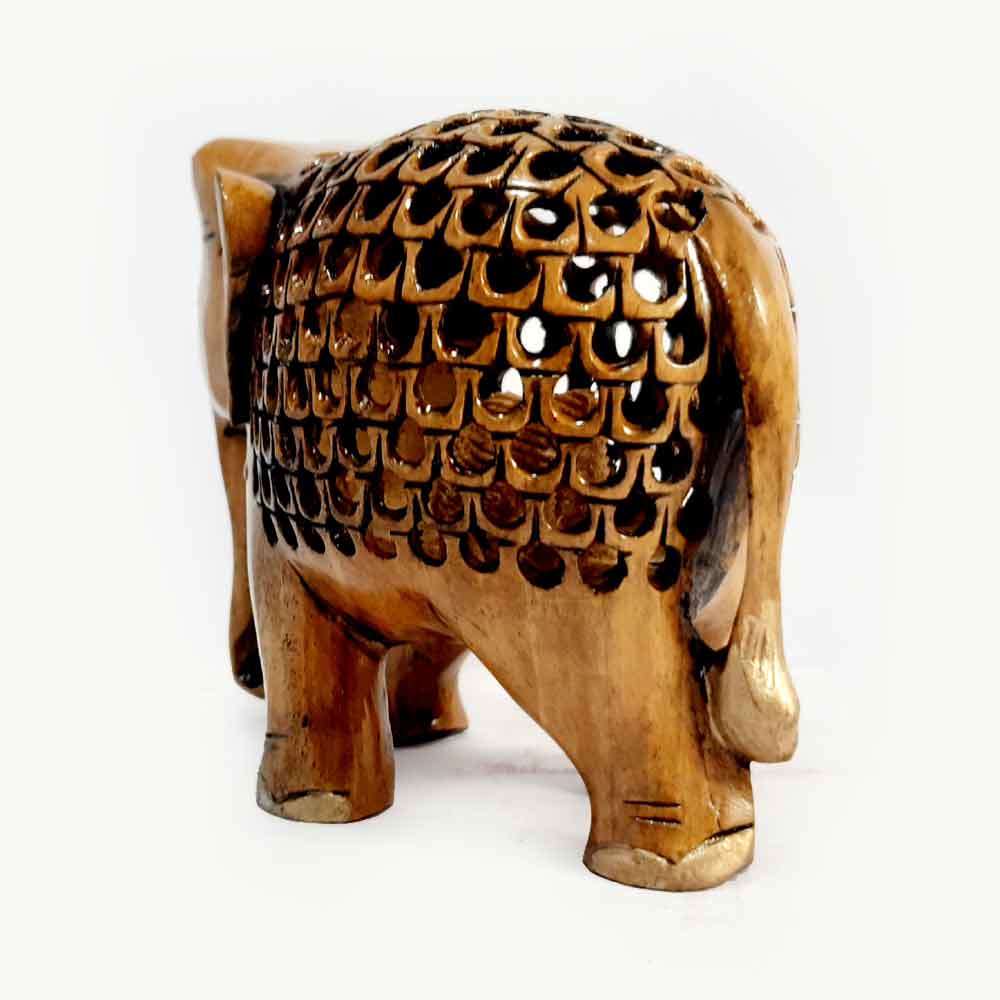 Antique wooden lattice elephant styled as home office decor centerpiece.