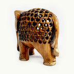 Antique wooden lattice elephant styled as home office decor centerpiece.