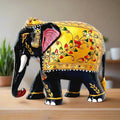  An embossed wooden elephant with a downward-facing trunk and beautiful floral painting.