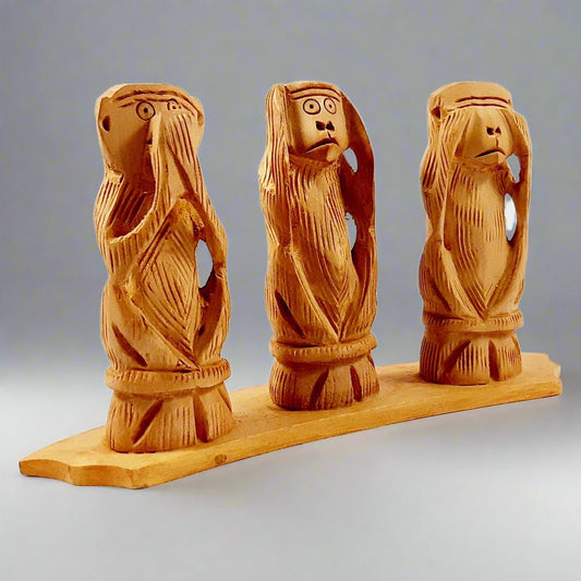 Hand carved wooden monkey covering ears, hear no evil from Gandhi set.
