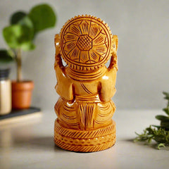 Back carving detail on round wooden Ganesh murti Vastu decor.