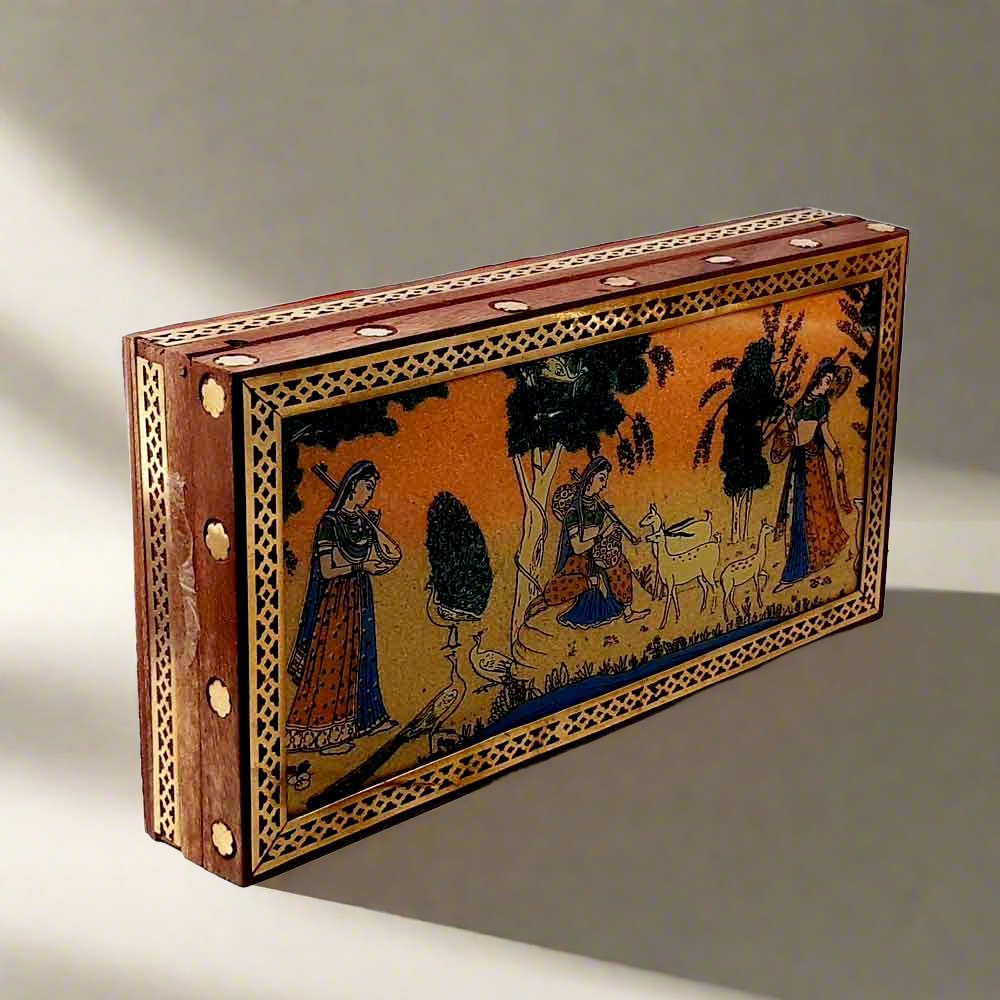 A gemstone-painted wood storage box, perfect for keeping earrings, chains, and other small jewelry items.