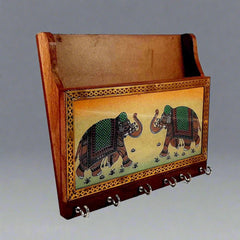 Intricate handmade gemstone painting detail on traditional wooden key holder.