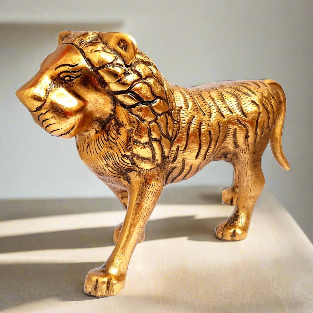Handcrafted golden metal lion statue Durga vahana closed-mouth front view.