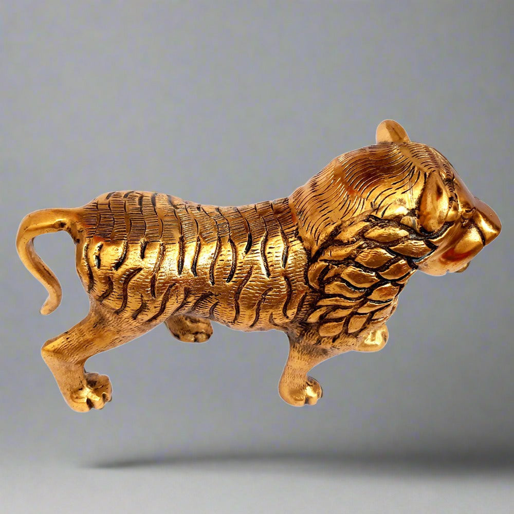 Gleaming golden polish detail on traditional Jaipur metal lion showpiece.