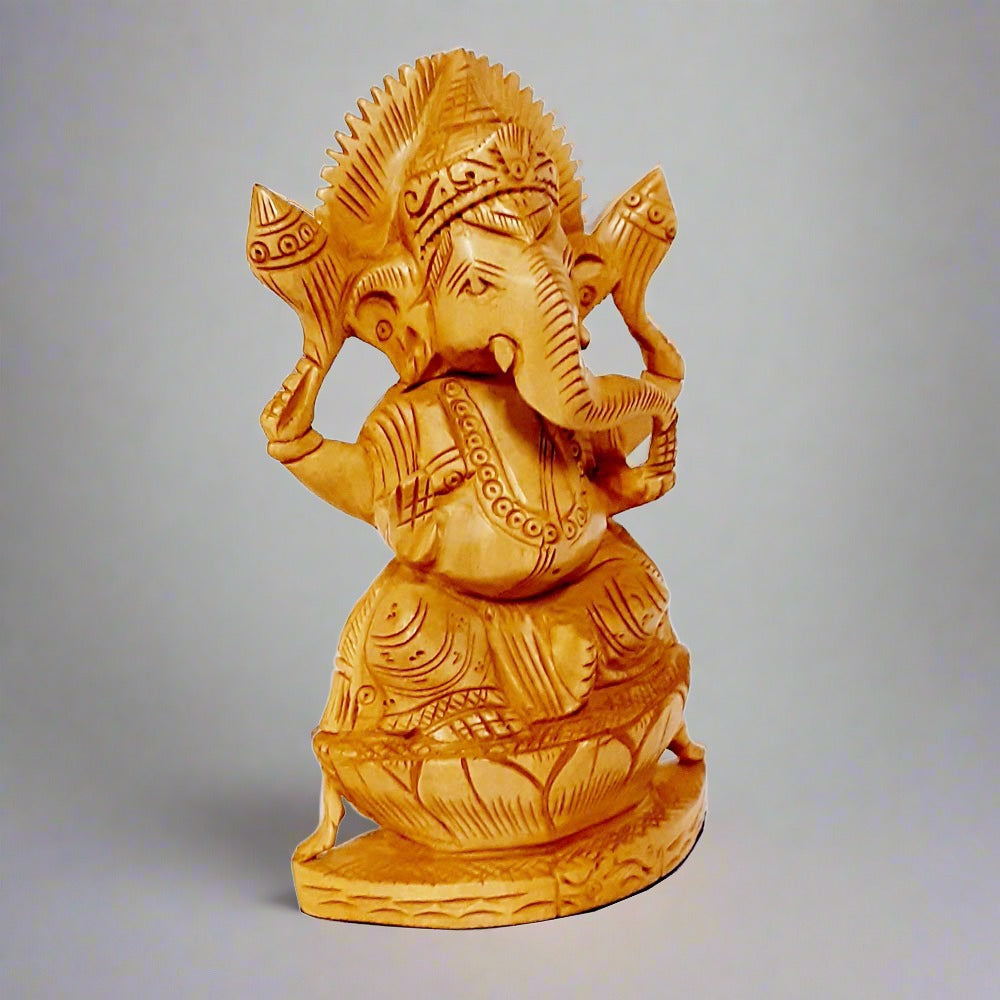 A gorgeous Ganesh figurine with a superb design, seated on a wooden lotus base.