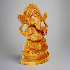 A gorgeous Ganesh figurine with a superb design, seated on a wooden lotus base.