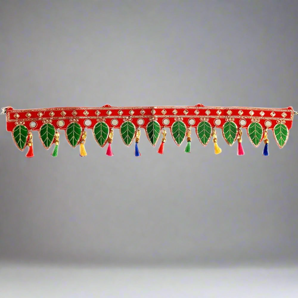 Close-up sequins, threads, pearls, fancy tassels detail on handmade green leaf bandarwal