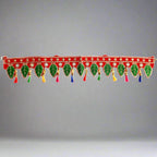 Close-up sequins, threads, pearls, fancy tassels detail on handmade green leaf bandarwal