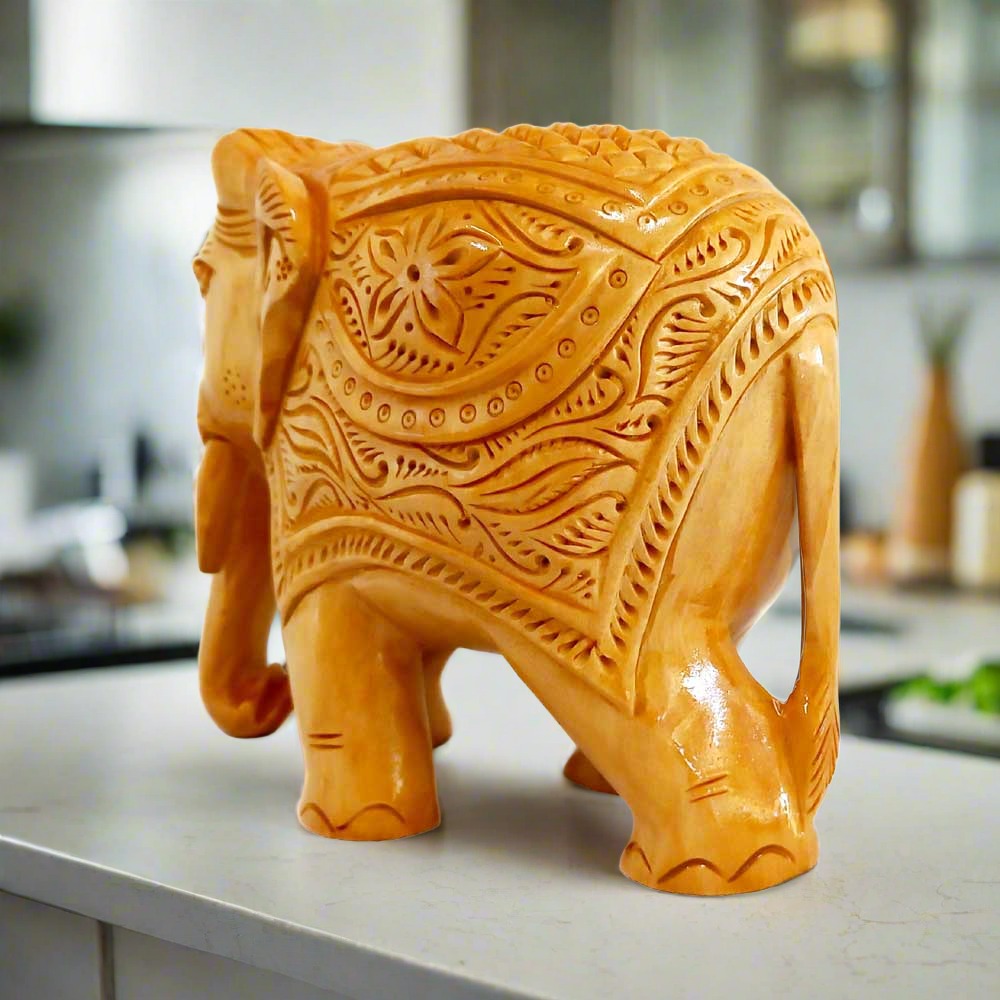 Hand-carved wooden elephant figurine with intricate detailing and fine craftsmanship.