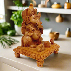 Hand-carved wooden Ganesh ji idol on chowki with two rats and laddu, crafted beautifully for worship spaces.