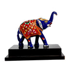 Closeup of blue hand-meenakari enamel work on metal elephant showpiece.